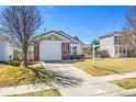Lovely single-Gathering house with a two-car garage and a well-kept lawn on a sunny day at 200 Vista Blvd, Brighton, CO 80603