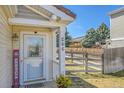 Inviting front porch with a decorative door, house numbers, and a well kept lawn at 200 Vista Blvd, Brighton, CO 80603