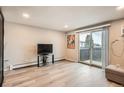 Bright living area with sliding glass doors to balcony and minimalist design at 65 N Clarkson St # 604, Denver, CO 80218