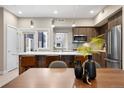 Stylish kitchen with stainless steel appliances, a quartz countertop island, and modern barstools at 4469 Tennyson St # 15, Denver, CO 80212