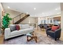 Bright and modern living space with contemporary furniture, open to dining and kitchen areas at 4469 Tennyson St # 15, Denver, CO 80212