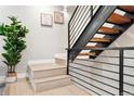 Modern staircase features black metal railings and wooden steps, complemented by stylish decor at 4469 Tennyson St # 15, Denver, CO 80212