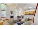 Bright living room featuring high ceilings, a fireplace, and an open floor plan, creating a spacious and inviting atmosphere at 13673 Cook St, Thornton, CO 80602