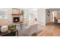 Spacious living room with a fireplace and hardwood flooring at 205 Hawthorn St, Frederick, CO 80530