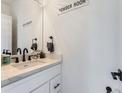 Stylish powder room featuring modern fixtures, a sleek vanity, and contemporary design elements at 1472 Yates St, Denver, CO 80204