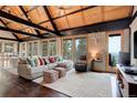 Spacious living room featuring a vaulted wood ceiling, large windows with a view, and comfortable, stylish furnishings at 116 Ramona Rd, Golden, CO 80403