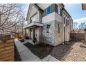 Modern two-story home showcasing a stone facade, contemporary design, and a well-maintained walkway at 2224 W 37Th Ave, Denver, CO 80211