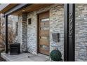 Charming entryway featuring a sleek wood door, stone cladding, and modern address numbers at 2224 W 37Th Ave, Denver, CO 80211