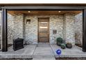 Inviting front entrance with a stylish wood door, stone accents, and modern design details at 2224 W 37Th Ave, Denver, CO 80211