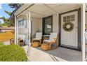 Inviting front porch featuring rocking chairs, a small table, and a decorative wreath, offering a cozy outdoor space at 4312 Xavier St, Denver, CO 80212