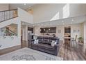 Open-concept living room with hardwood floors, high ceilings, and lots of natural light at 1202 Lance Leaf Ct, Elizabeth, CO 80107