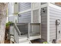 Close up of the front porch with gray siding and a white security door at 6545 W 84Th Way # 132, Arvada, CO 80003
