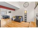 Bright living room featuring hardwood floors, a fireplace, and a large window at 6545 W 84Th Way # 132, Arvada, CO 80003
