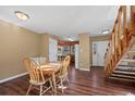 Cozy dining area featuring hardwood floors, stairs, and seamless transition to the kitchen for easy entertaining at 4311 Del Rio Ct, Denver, CO 80239