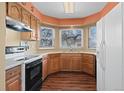 Functional kitchen with stainless appliances and a window overlooking the yard, filling the space with natural light at 4311 Del Rio Ct, Denver, CO 80239