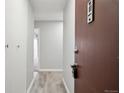 Bright hallway with a neutral color scheme and wood-look flooring at 1121 Albion St # 804, Denver, CO 80220