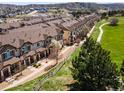 Aerial shot of townhomes with beautiful golf course views, surrounded by lush greenery at 1344 Royal Troon Dr, Castle Rock, CO 80104