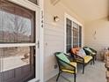 Cozy front porch seating area, perfect for enjoying the outdoors and relaxing in style at 1344 Royal Troon Dr, Castle Rock, CO 80104