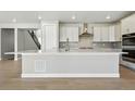 Modern kitchen with quartz countertops, stainless steel appliances, and a large island at 9329 Russell Cir, Arvada, CO 80007