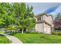 Charming home exterior featuring lush greenery and a well-maintained lawn at 6598 S Telluride St, Aurora, CO 80016