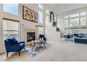 Bright living room with a fireplace, high ceilings, and large windows at 6598 S Telluride St, Aurora, CO 80016