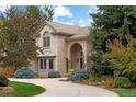 Two-story house with a tan brick exterior and landscaped grounds at 5320 S Race Ct, Greenwood Village, CO 80121