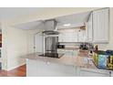 Kitchen island features granite countertops and modern black range at 5512 S Greenwood St, Littleton, CO 80120