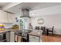 Modern kitchen with granite counters, stainless steel, island, and breakfast nook at 5512 S Greenwood St, Littleton, CO 80120