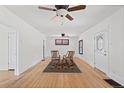 Bright living room featuring hardwood floors, ceiling fans, white walls, and charming vintage furnishings at 3225 S Sherman St, Englewood, CO 80113