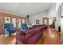 Cozy living room features vaulted ceilings, a hardwood floor and comfortable seating at 9107 S Deer Creek Canyon Rd, Littleton, CO 80127