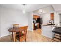 Eat-in kitchen features stainless steel appliances, breakfast bar, and adjoining dining area at 7468 S Alkire St # 205, Littleton, CO 80127