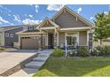 Charming home with a well-manicured lawn and landscaping, plus a welcoming front porch area at 5495 Espana Ct, Denver, CO 80249