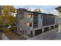 New townhome showing multi-level gray exterior with stone accents, a private garage, and contemporary design at 1524 Ingalls St, Lakewood, CO 80214