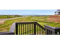 Scenic backyard view from a wooden balcony overlooking a green landscape with a road and neighborhood in the distance at 9382 Quaker St, Arvada, CO 80007
