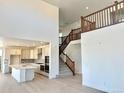 Open concept home featuring a kitchen and staircase with wood handrails at 9382 Quaker St, Arvada, CO 80007