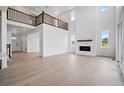 Bright living room with soaring ceilings, a modern fireplace, and large windows, creating an airy and inviting space at 9382 Quaker St, Arvada, CO 80007