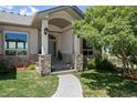 Charming front entrance featuring stone pillars, a walkway and lovely landscaping at 4002 Bell Mountain Dr, Castle Rock, CO 80104
