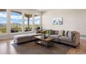 Cozy living room with natural light, comfortable seating and stunning views at 4002 Bell Mountain Dr, Castle Rock, CO 80104