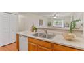 A well-lit kitchen is showcased with stainless steel appliances, double sink, and an open view to the living room at 9650 Huron St # 12, Thornton, CO 80260