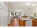 Cozy living room with hardwood floors, modern decor, and a view into the dining area through an opening at 9650 Huron St # 12, Thornton, CO 80260