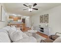 Inviting living room flows into the kitchen with hardwood floors and natural light at 9650 Huron St # 12, Thornton, CO 80260