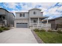 Charming two-story home with stone accents, a covered porch, and well-maintained landscaping at 5201 Lumos Ln, Castle Rock, CO 80104