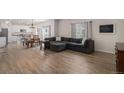 Open-concept living area flows seamlessly into the kitchen, featuring wood floors and ample natural light at 5201 Lumos Ln, Castle Rock, CO 80104