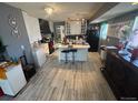 Spacious kitchen with tile floors, an island, and black appliances at 1171 Geneva St, Aurora, CO 80010