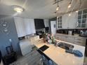 Bright kitchen featuring white cabinets, large sink and modern lighting at 1171 Geneva St, Aurora, CO 80010