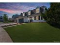 Charming two-story home featuring dormer windows and a well-manicured lawn at dusk at 6330 E Irwin Pl, Centennial, CO 80112