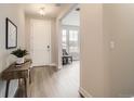 Bright entryway with hardwood floors, a white door, and views into the living room at 3140 Newfound Lake Rd, Berthoud, CO 80513