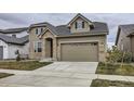 Charming two-story home featuring stone accents, a two-car garage, and well-maintained lawn at 3140 Newfound Lake Rd, Berthoud, CO 80513