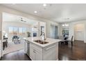 Bright, open kitchen with a central island, stainless steel appliances, and seamless flow into the living and dining areas at 12597 W Big Horn Cir, Broomfield, CO 80021