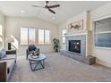 Vaulted ceilings, a cozy fireplace, and large windows make this living room feel open and inviting at 12597 W Big Horn Cir, Broomfield, CO 80021